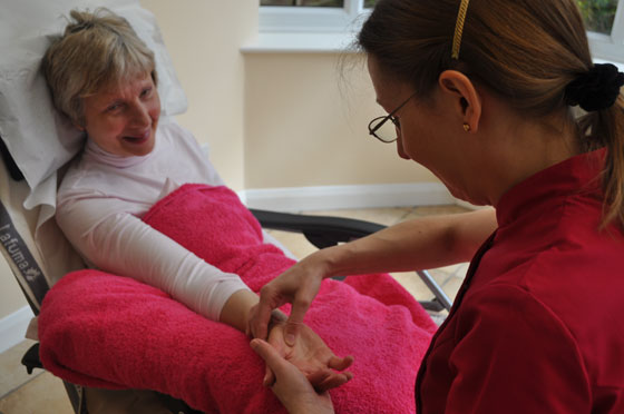 Fiona giving reflexology treatment to a client